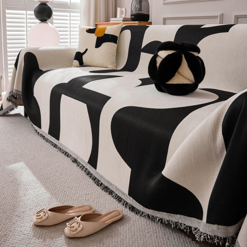 Neatly folded grey sofa throw cover on a modern UK sofa