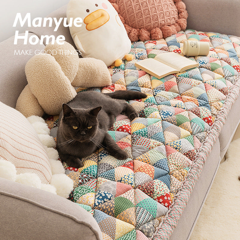 Grey sofa throw cover and knitted blanket contrasting on a modern sofa